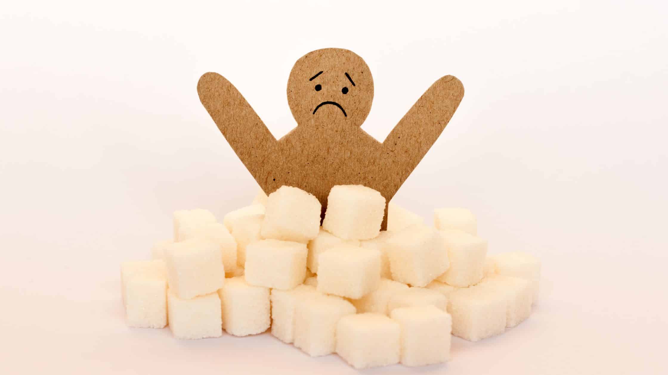 Stick figure surrounded by sugar cubes representing insulin resistance